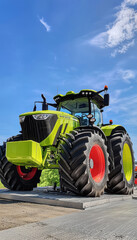 Obraz premium Innovative Modern Tractor Showcasing Advanced Design on Rural Farm Stage with Blue Sky Background