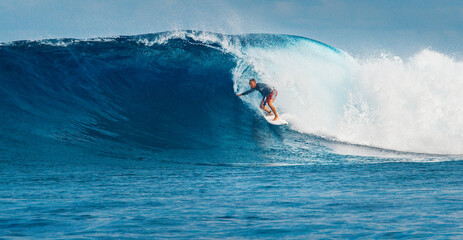 Pro surfer rides big wave in the Maldives