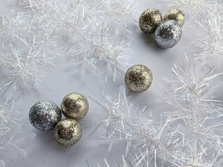 Gold and silver Christmas balls between white Christmas decorations