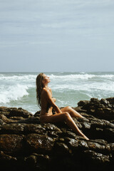 woman on the rocks in the beach