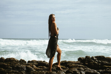 Woman on the rocks of a beach