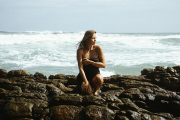 Woman on the rocks of a beach