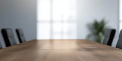 Fototapeta premium A professional conference room setting featuring a beautifully polished wooden table under soft diffused light, creating a serene atmosphere for collaboration and discussion.