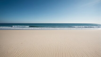 a sandy beach with waves crashing on the shore