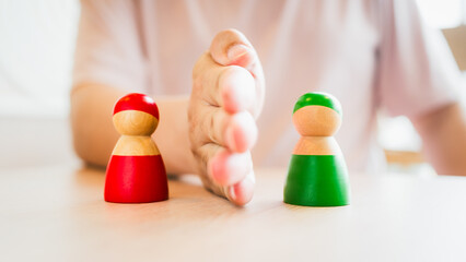 Red and green wooden figures teams against opponent or enemy. Strategy, Conflict, management, business planning, tactic, politic, communication and leader concept