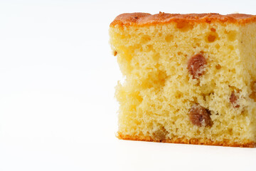 Moist cake slice with raisins displayed against a plain white background during a casual baking event