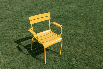 a yellow chair on the lawn