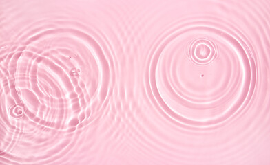 water texture ripple wave transparent water abstract background in pink tones