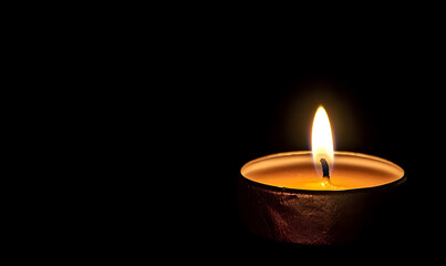 A lit candle in a dark setting, symbolizing warmth and tranquility.