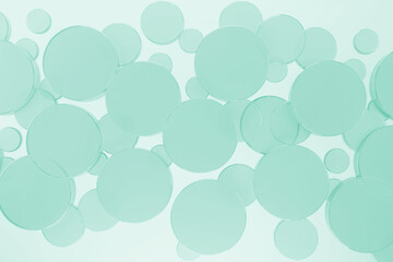 Mint green flying smooth transparent glass circles pattern on white abstract background, top view. 3D illustration - circles texture in purity, cosmetic, geometric style for sale, advertising, design.