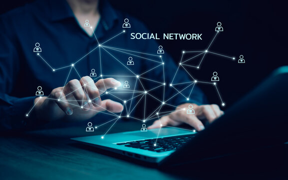 Businesswoman hand using laptop to play social media,Human icon with a notification people icon,Social network ,Teamwork Concept, international consulting company. Social networking hologram icons.