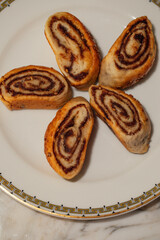 plate with five Iraqi Kleica spiral cookies made with date paste