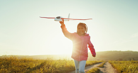 Happy child, toy airplane and running outdoor for game, freedom or travel on mockup space. Smile,...