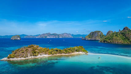 Aerail view of  tropical exotic island sand bar separating sea in two with turquoise  in El Nido, Palawan, Philippines.