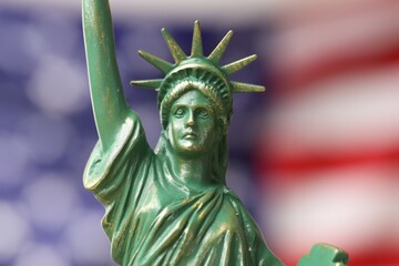 Statue of Liberty against flag of USA, closeup