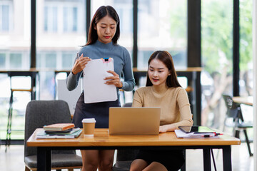 Fototapeta premium Two Business Documents, Auditor businesswoman checking searching document legal prepare paperwork or report for analysis TAX time,accountant Documents data contract partner deal in workplace office 