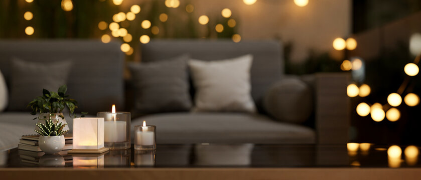 A coffee table in a beautiful living room at night featuring glowing lights create a warm atmosphere
