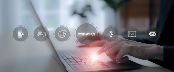 Contact us, customer service channel concept. Using laptop and virtual screen icons of customer contact channels and services (address, phone, email, live chat, self service, social media, video chat)