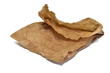 A crumpled paper grocery bag lies on a white background.