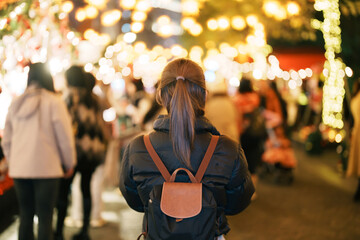 happy tourist woman stands on a German christmas market . Merry Christmas, holiday and happy New Year concept