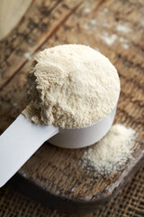 Whey protein powder in a measuring cup
