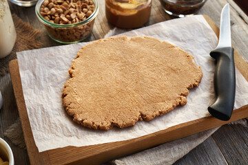 Rolled out dough made of whey protein powder, peanut butter and maple syrup - ingredient for homemade protein bars