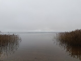 Rekyva lake during cloudy day. Cloudy day with white and gray clouds in sky. Wavy lake. Horizon over water. Rekyvos ezeras.	
