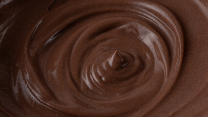 Dark chocolate mousse, cocoa milk cream spiral texture as background. Macro photo. Chocolate mousse background