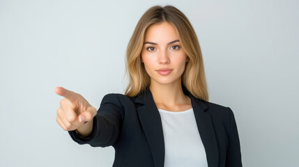 Business professional asserting authority with an accusatory finger gesture in a minimalist office space