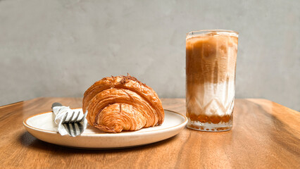 coffee and croissant on the cafe table