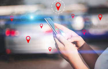 Hands holding a smartphone with digital navigation pins overlayed on a blurred car background, symbolizing GPS technology.