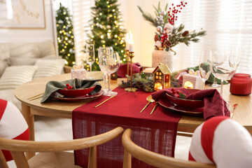 Christmas table setting with stylish dishware and festive decor indoors