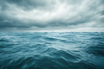 Dark, turbulent ocean waves under a cloudy sky.
