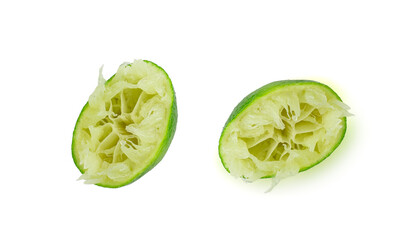 Squeezed lime, squeezing out half green lemon, squeezed lime juice on white background, burnout...