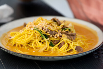 Chiang mai curry noodles, asian spicy egg pasta with meat, curried noodle soup Khao Soi or Khao Sawy, thai food