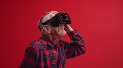Fototapeta premium An elderly man wearing opaque virtual reality goggles, laughing with an open mouth