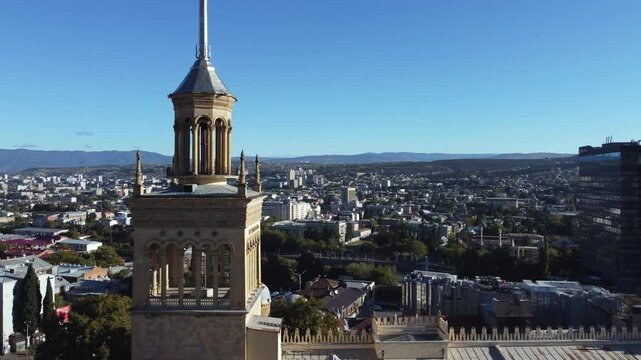 Aerial flies past steeple tower on Academy of Sciences, Tbilisi Georgia