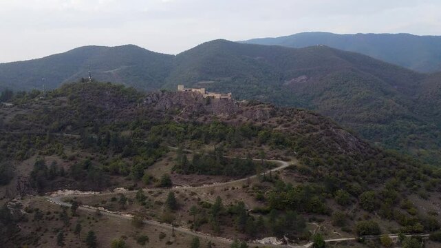 Aerial of Modinakhe Castle on rocky mountain ridge in Caucasus Mtns