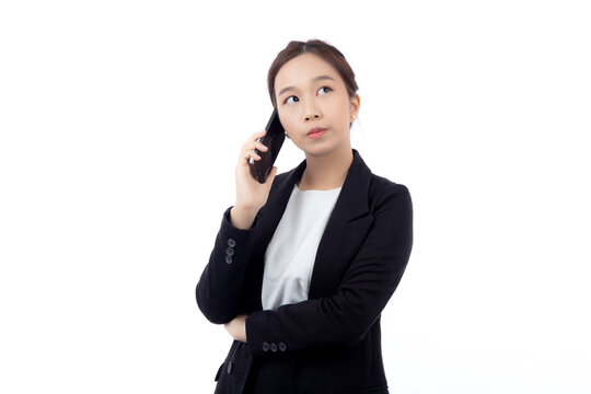 Portrait young asian businesswoman in suit thinking while talking on smartphone with doubt isolated white background, business woman thoughtful while speaking on smart phone with expression pondering.