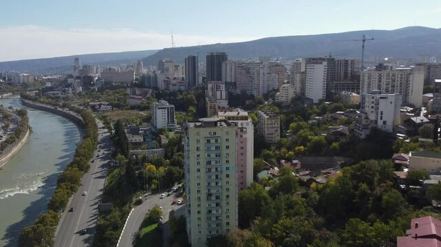 Flyover Kura River through modern downtown, city of Tbilisi, Georgia