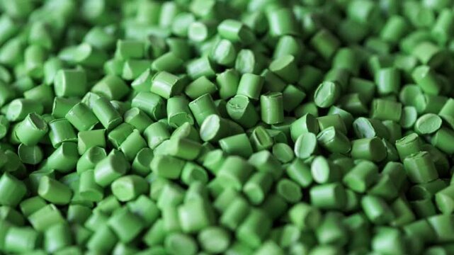 video of green plastic granules moving in a circle with distance