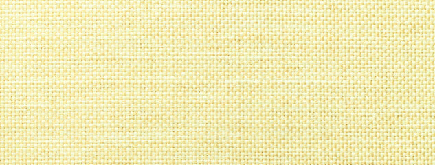 Texture light yellow background from woven textile with wicker pattern, macro. Structure vintage fabric