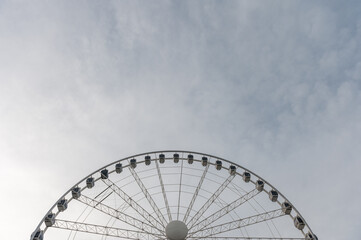 Wheel of Manchester. Majestic Ferris Wheel Under a Vast Cloudy Sky on a Clear Day