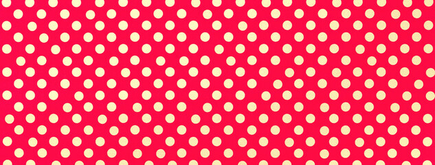 Bright red background from wrapping paper with pattern of yellow polka dot, macro.