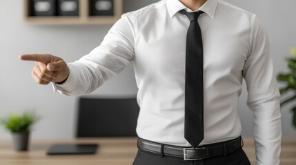 A professional businessman in a white shirt and black tie, assertively pointing in an office, representing leadership, direction, and clear communication in business dynamics.