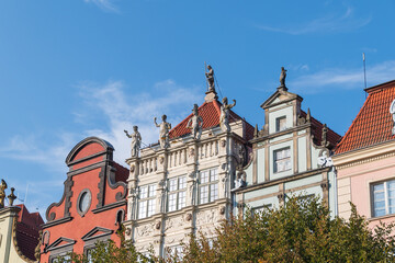 The Golden House. The facade of the building decorated with bas-reliefs and stone sculptures in the...