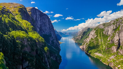Kjerag, Lysebotn, Lysefjorden, Norway, A breathtaking view of a Norwegian fjord, showcasing towering cliffs, lush greenery, and the crystal-clear waters of the fjord