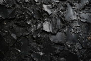 A black and white photo of a wall with a rough texture. The photo has a moody and mysterious feel to it