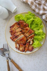 Homemade fried pork in ceramic plate on grey background	