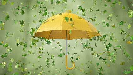 Summer green and yellow leaves falling on the yellow rotating Umbrella